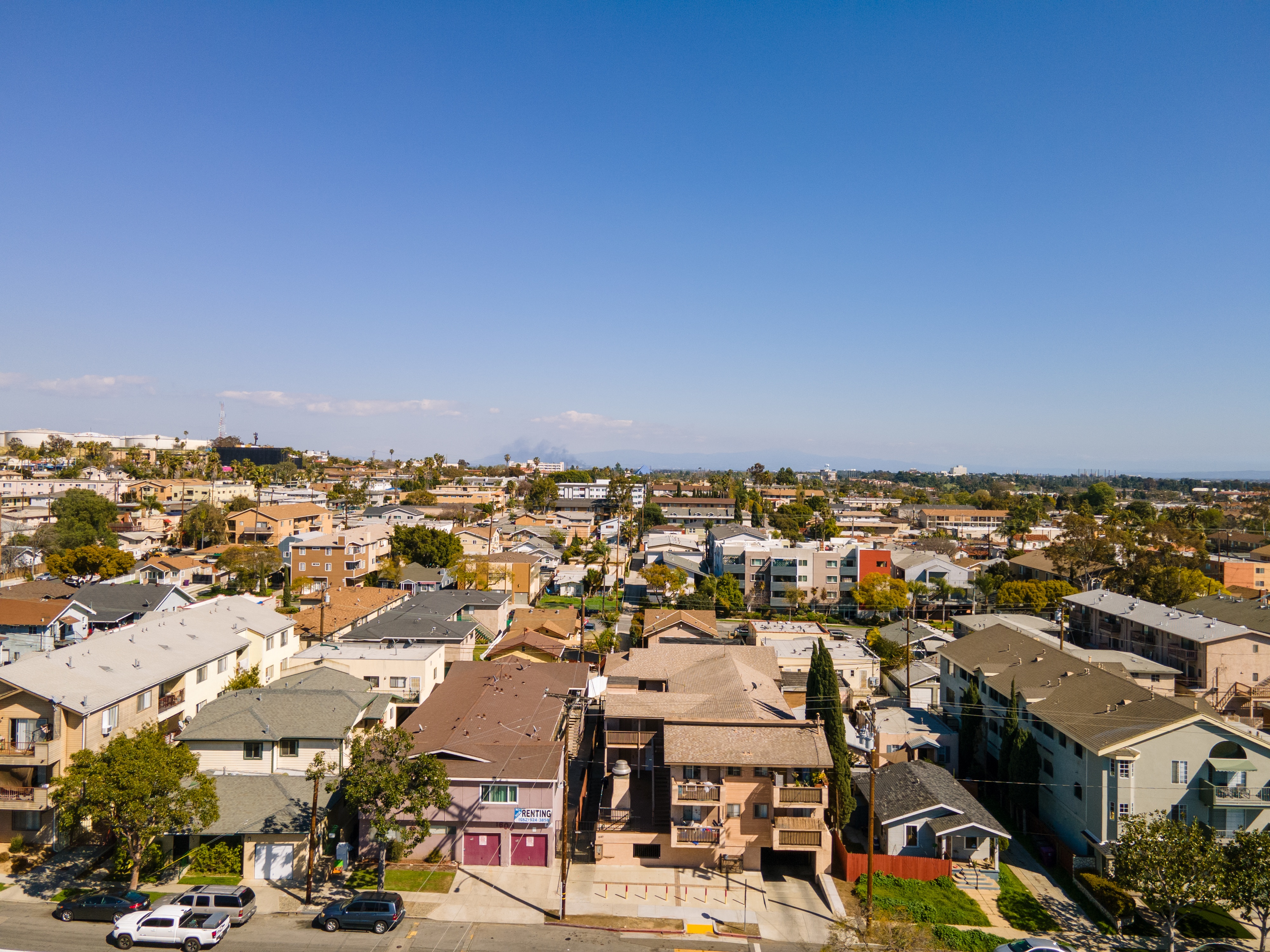 A residential area with houses and cars.